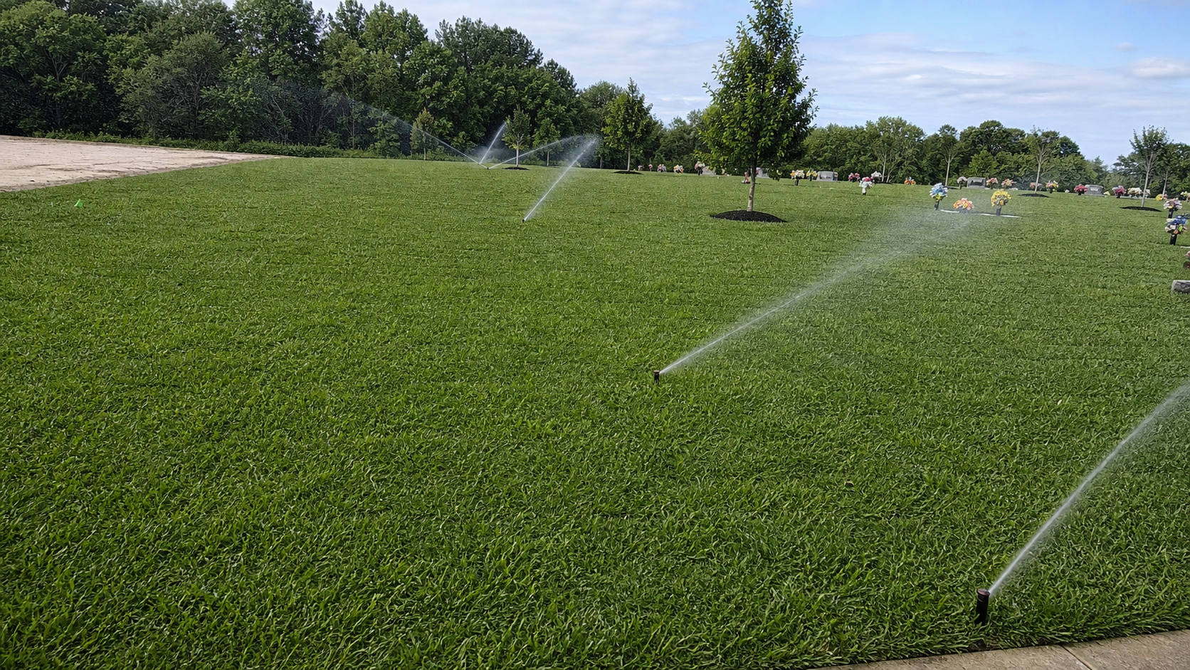 Completed irrigation system watering healthy green grass